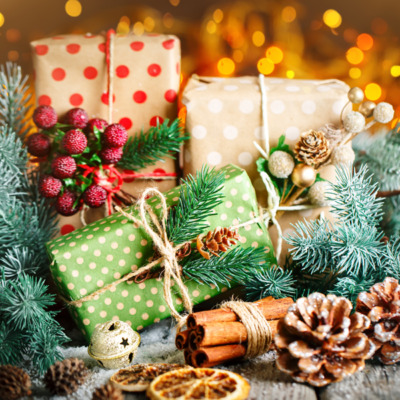 Merry Christmas and happy New year. Christmas gift and Christmas tree on dark wooden background.